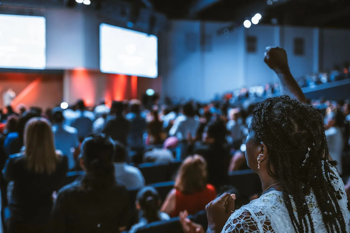 An audience seated in an auditorium during a leadership session